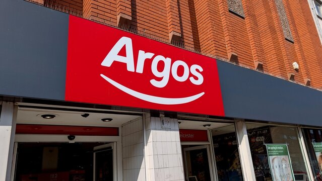 Leicester, England, UK - 21 March 2026: Argos store entrance in Leicester UK, red and white brand logo on black facade, retail shop with promotional posters in window