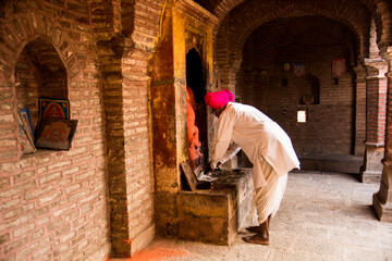 Fototapeta premium An Indian man prays at a Temple, India