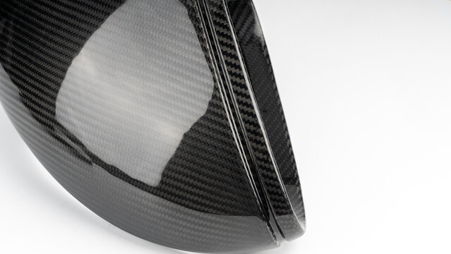 Glossy carbon fiber car side mirror cover isolated on white