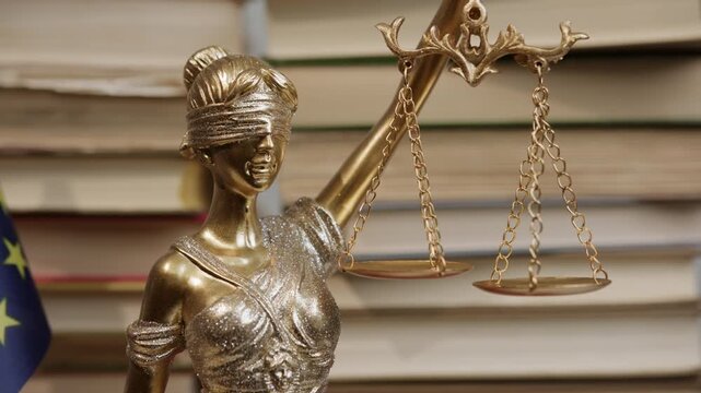 Statue of Justice with flag of European Union on background of stacks of law books in legal setting