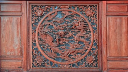 Wooden rustic wood carving depicting mythical dragon and phoenix bird.