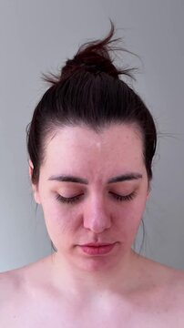Skincare Session With Cotton Pad On Face. Calm Woman Performing Facial Cleansing With Gentle Motions