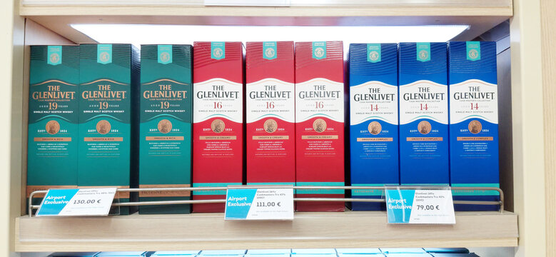 28 November 2025, Istanbul, Turkiye: Glenlivet single malt scotch whisky bottles displaying on a wooden shelf in an airport duty free shop. Retail display offering exclusive products