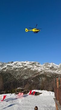 Rescue helicopter flying over the ski area