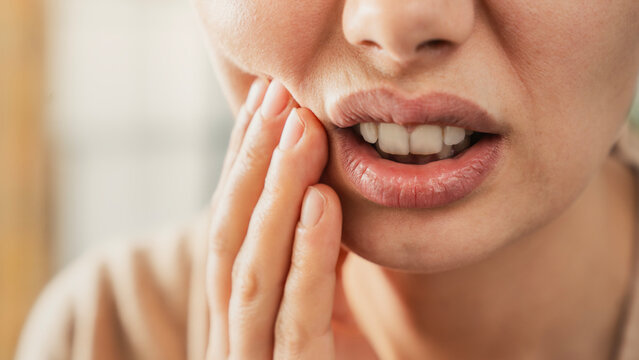 Young woman suffering from toothache
