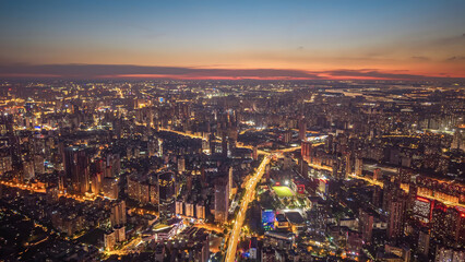 Wuhan Urban Skyline at Twilight with Illuminated Streets and Golden Hour Light © DoThi