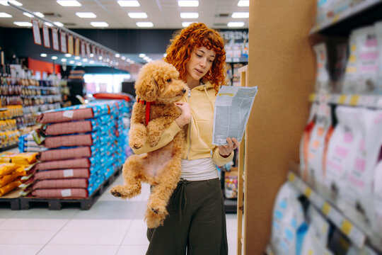 Happy woman buying a leash at a pet shop