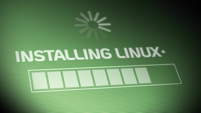 Close-up of a computer screen showing &ldquo;Installing Linux&rdquo; with a loading spinner and progress bar. Concept of software installation, coding, and operating system setup. 15106