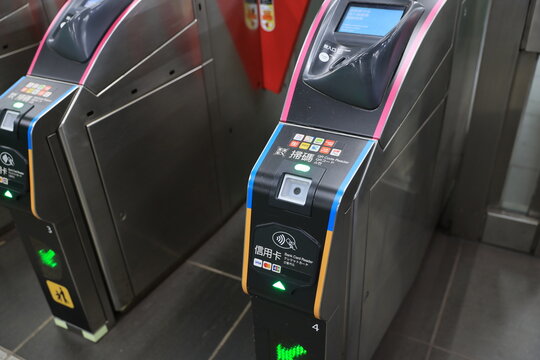 Automatic subway ticket gates with mobile payment and credit card readers.