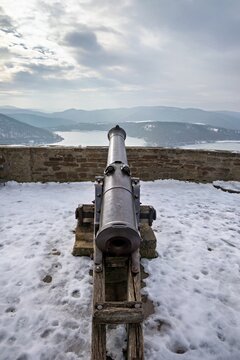Front View of Historic Castle Cannon Pointing Over Frozen Ederse