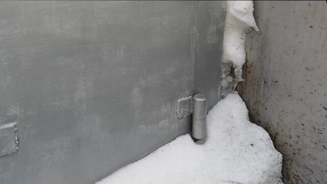 Metal hinges attached to a gray wall with snow accumulation at the base, showcasing the gradual transition of the hinge position in three sequential frames