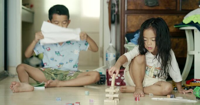 Adorable littl shcool boy enjoy play car toy with block building in cozy room education concept