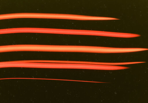 Opening text frame with red light trails across black for teaser copy, cast billing and event naming where bright horizontal streaks shape a dramatic space for words