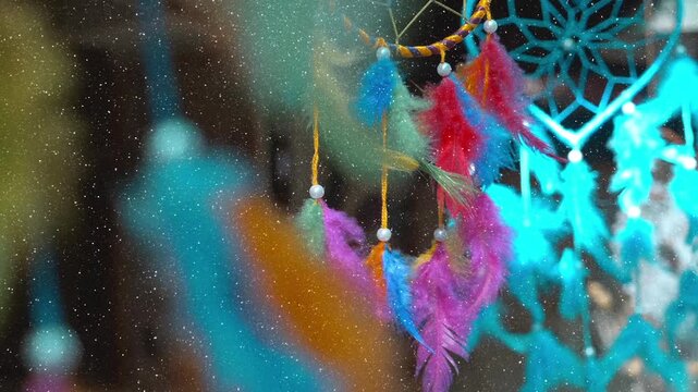 Indian traditional colorful, gentle Dream Catchers fluttering in the wind attracting tourists to buy in the city of Pushkar, India. View through sparkling particles. Slow mo, slo mo, slow motion