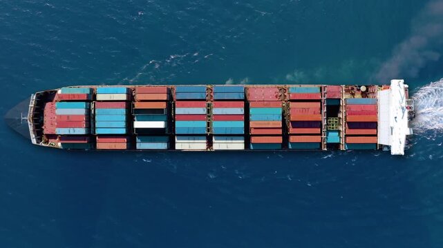 Container ship transporting cargo across the ocean highlights global trade challenges and supply chain issues