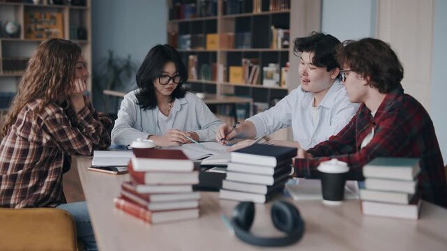 Diverse students studying and collaborating together in a college library