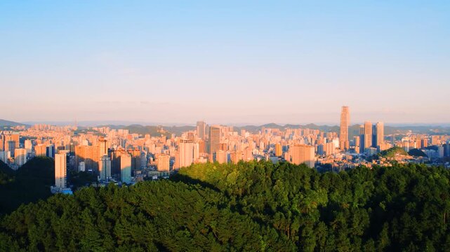 Guiyang skyline at sunset above forest and mountains