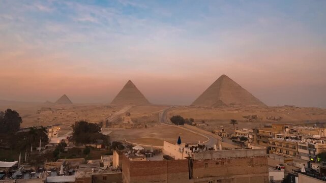 Cinematic drone shot of Egyptian pyramids in desert landscape at sunset