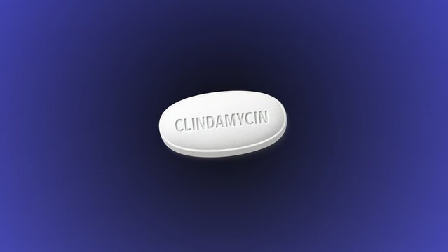 Clindamycin antibiotic medication used to treat bacterial infections. Lincosamide class drug with skeletal formula molecule concept. Medicine for sale at pharmacy drugstore on dark background.