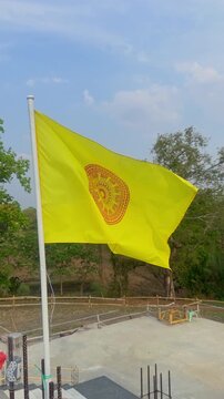  Yellow Dharmachakra Buddhist Flag Waving in Wind Symbol of Thailand Cultural Identity , Vertical video.