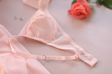 Naklejka premium Woman's lingerie on the bed sheets. Lace sexy female underwear. Beauty, fashion blogger concept. Female bra, panties, erotic clothes. Lingerie advertising