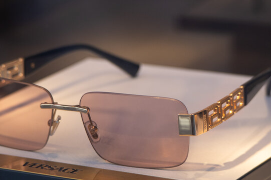 Rectangular sunglasses with rose-tinted lenses, model VE2298, featuring the Versace Greca pattern on the temples.Milan - Italy,28 March 2026