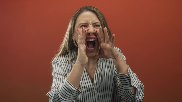 Woman in a striped shirt shouting with cupped hands around her mouth in a studio; urgent announcement.