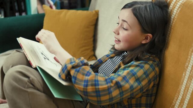 Happy preteen girl reading a book on a cozy couch at home, smiling preteen child enjoying literature in a bright living room, 4K high quality lifestyle photography.
