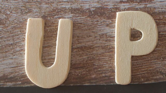 wooden letters forming the word up
