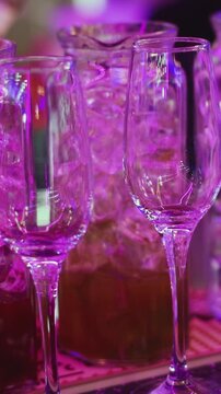 Barman mixing and pouring drinks and beverages, beautiful row line of different coloured lemonades in a jar, liquor alcohol cocktails on a party in bar, catering banquet on event, mocktails in a jug 