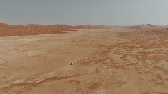 Vehicle drives through sand dunes of Empty Quarter, Rub al-Chali in Oman