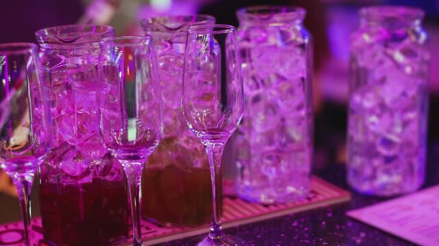 Barman mixing and pouring drinks and beverages, beautiful row line of different coloured lemonades in a jar, liquor alcohol cocktails on a party in bar, catering banquet on event, mocktails in a jug 