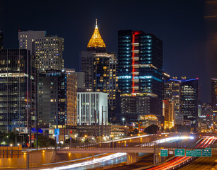 Obraz premium Atlanta Night Skyline with Light Trails on Highway and Illuminated Midtown Towers