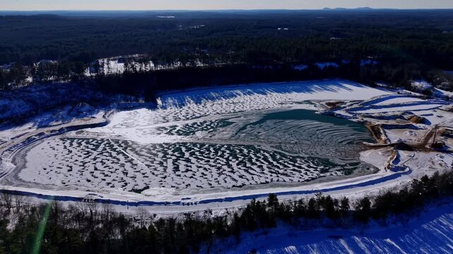 Winter aerial view featuring a frozen quarry in Dover, New Hampshire