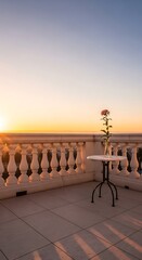 Fototapeta premium Romantic balcony at sunrise with a single rose on a table overlooking a cityscape, golden hour light