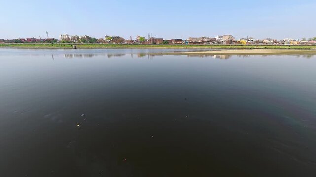 Indian jamuna agra scenic view of a river with a cityscape on the horizon 4k stock slow motion  video footage.