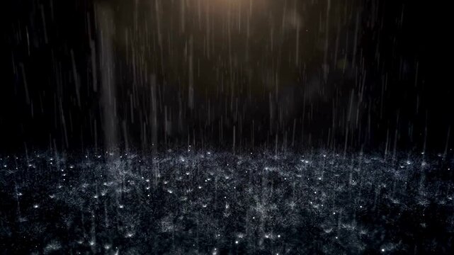 Heavy rain falling on dark surface with warm glow. Night rainfall sparkling drops splashing on dark water surface background.