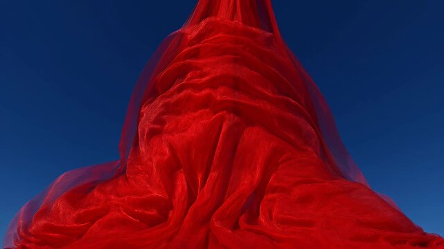 Abstract billowing fabric in rich red hue against vibrant azure blue sky
