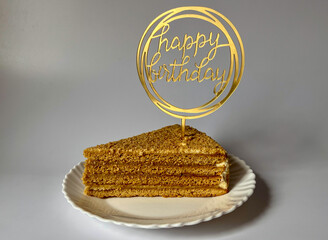 a piece of delicious cake on a white plate on a white background, happy birthday greetings © Polina_mrtnk