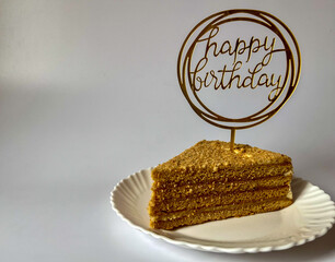 a piece of delicious cake on a white plate on a white background, happy birthday greetings © Polina_mrtnk