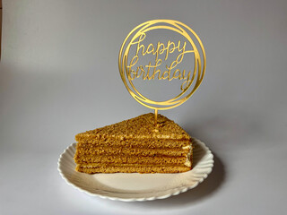 a piece of delicious cake on a white plate on a white background, happy birthday greetings © Polina_mrtnk