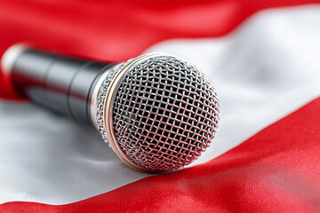 Close up on a Microphone on Austrian flag background, radio or music live show event, international song contest in Austria