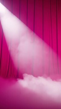 Bright spotlight illuminates smoky stage with pink curtains