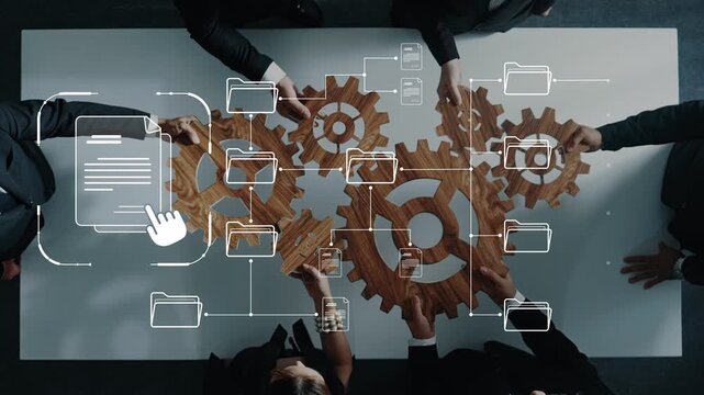 A diverse business team collaborates over a table, using gears and digital icons to represent workflow and data management, emphasizing innovation and teamwork. Raster