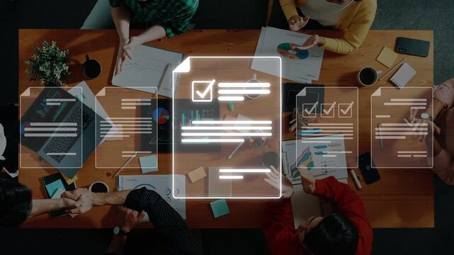 A diverse team engages in project planning at a modern workspace, emphasizing collaboration and innovative thinking with documents and technology on the table. Raster