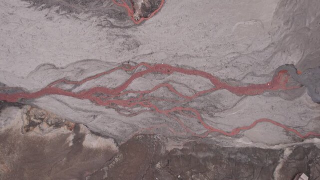 Abstract textures on the drained reservoir floor at Vidraru Dam with mineral patterns and sediment layers