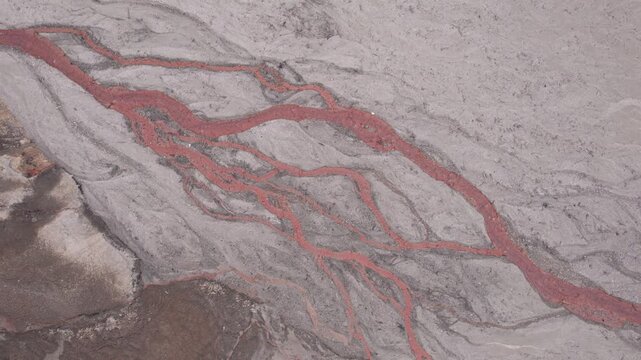 Abstract textures on the drained reservoir floor at Vidraru Dam with mineral patterns and sediment layers