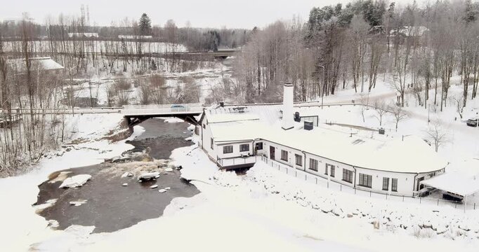 Aerial view of Vantaankoski rapids and Vanha Viilatehdas (The Old File Factory), which now operates as a restaurant and event venue in cloudy winter weather, Vantaa, Finland, Europe.