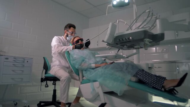 Dentist treats teeth to a beautiful young blonde girl