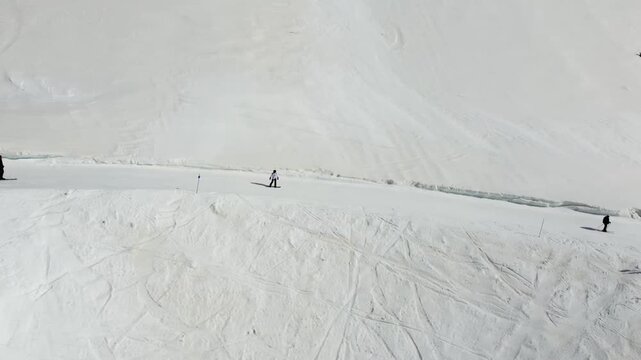 aerial view of snowboarder sliding down a snowy mountain